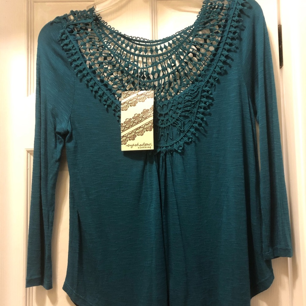 Beautifully detailed turquoise ladies shirt.